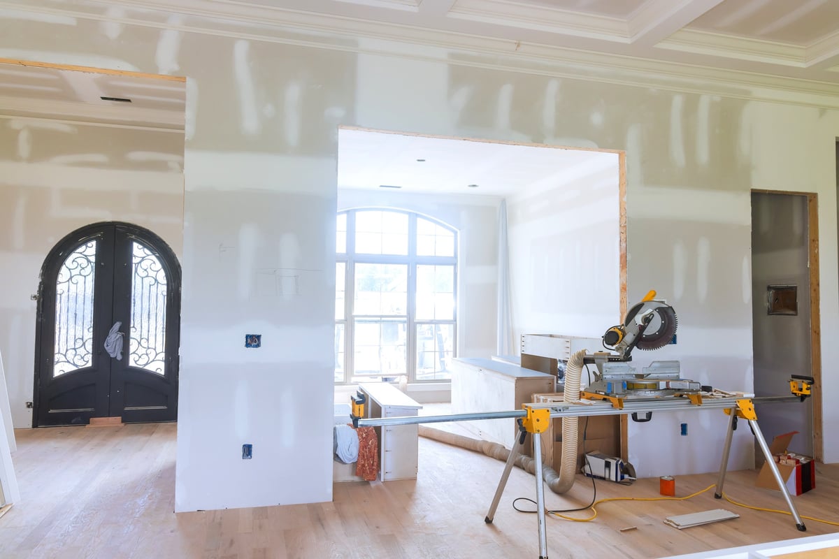 A modern space during a renovation with tools and unfinished walls