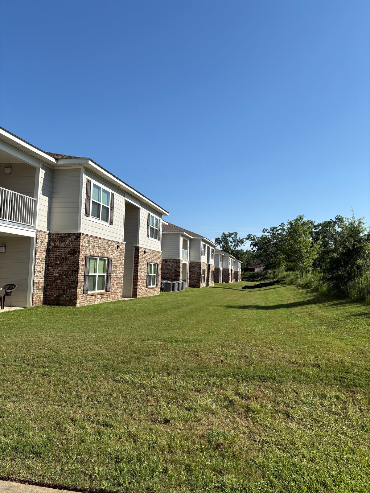 Modern brick and tan multifamily townhouses with well-maintained grounds maintained by Homepoint Property Group in the Dothan, Alabama area