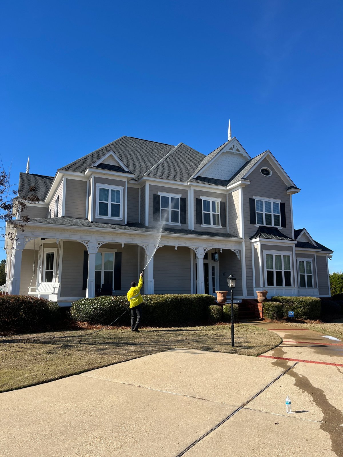Homepoint Property Group crew soft washing the exterior of a two-story home in Dothan, Alabama